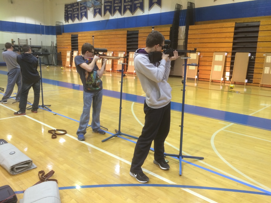 Students practice shooting air rifles