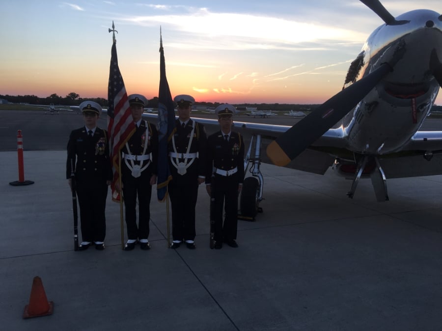 Students standing next to airplane